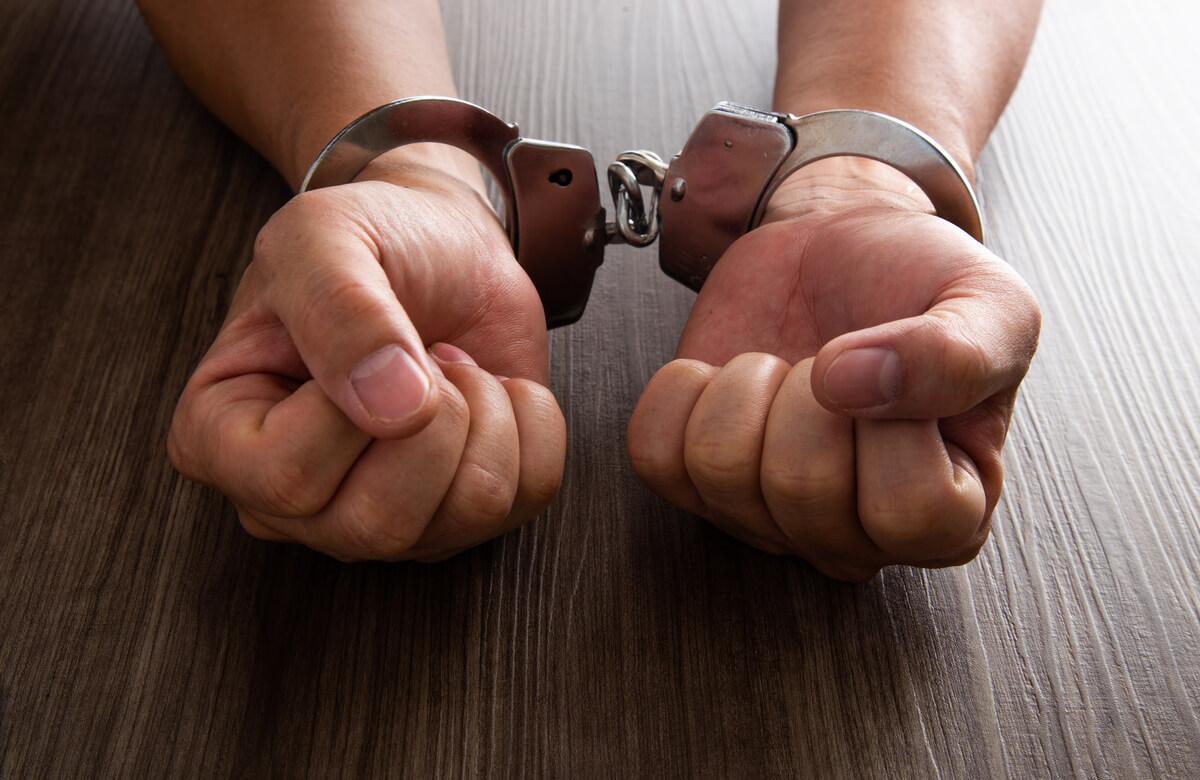 arrested-criminal-hands-locked-handcuffs